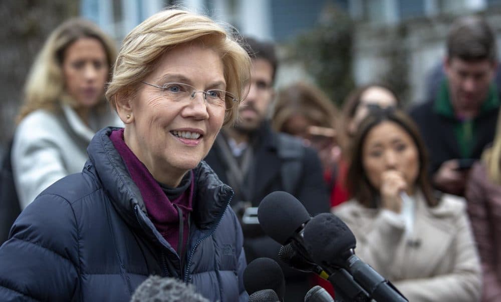 Massachusetts U.S. Sen. Elizabeth Warren talks with reporters outside her home in Cambridge after announcing that she is setting up an exploratory committee for a run for the presidency in 2020. (Robin Lubbock/WBUR)