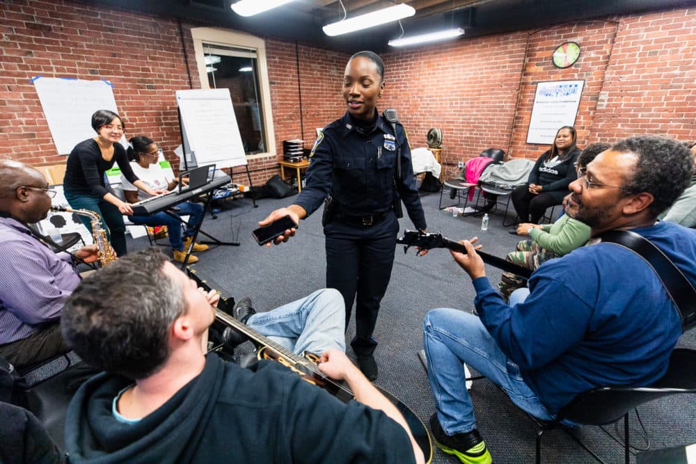 Kerline Desire, a Boston police officer, talks with colleagues at a &quot;Code Listen&quot; rehearsal. Desir says her experience with Code Listen reminds her that there’s “a story behind each victim we encounter on the streets. (Courtesy Celebrity Series)