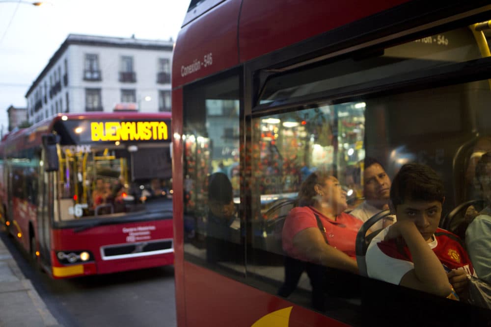 Commuters ride a &quot;Metrobus&quot; rapid transit bus as night falls in Mexico City, Friday, Dec. 2, 2016. (Rebecca Blackwell/AP)