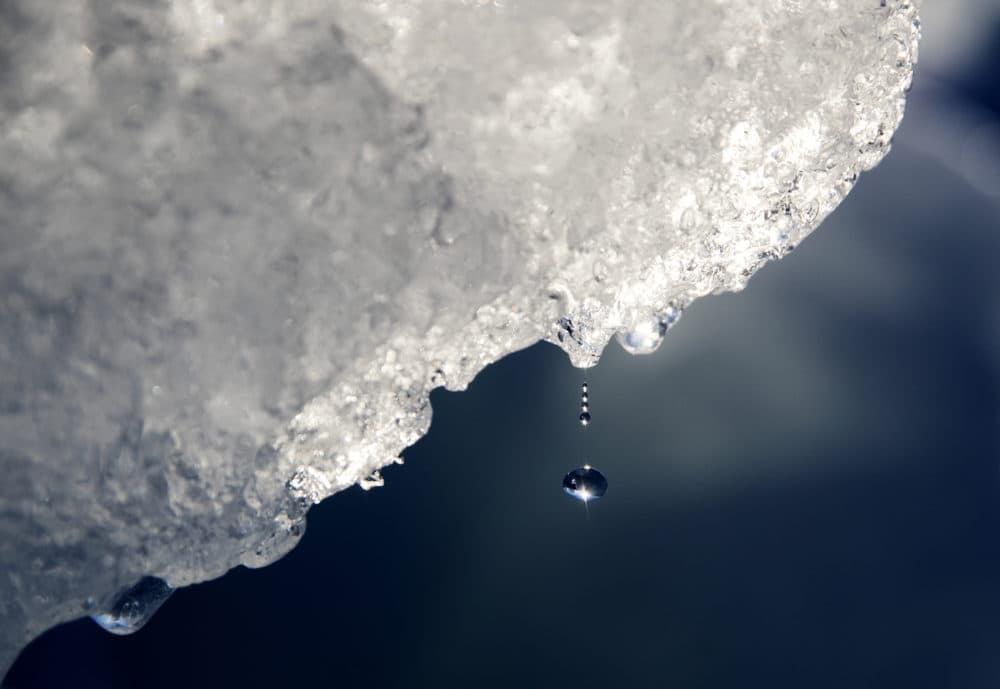 A drop of water falls off an iceberg melting in the Nuup Kangerlua Fjord in southwestern Greenland, Tuesday Aug. 1, 2017. Studies show the Arctic is heating up twice as fast as the rest of the planet. (David Goldman/AP)