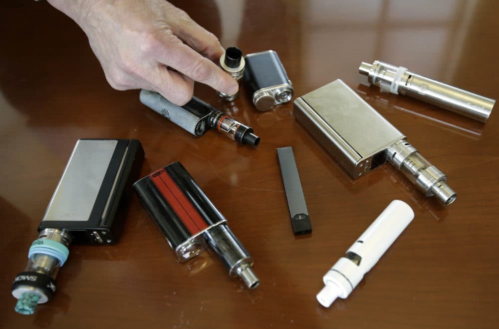 Marshfield High School Principal Robert Keuther displays vaping devices that were confiscated from students in such places as restrooms or hallways at the school in Marshfield, Mass. Health and education officials across the country are raising alarms over wide underage use of e-cigarettes and other vaping products.
The devices heat liquid into an inhalable vapor that's sold in sugary flavors like mango and mint, and often with the addictive drug nicotine. (Steven Senne/AP)