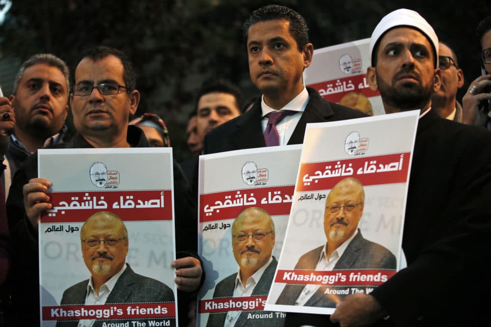 Activists protesting the killing of Saudi journalist Jamal Khashoggi hold a candlelight vigil outside Saudi Arabia's consulate in Istanbul in Oct. (Lefteris Pitarakis/AP)