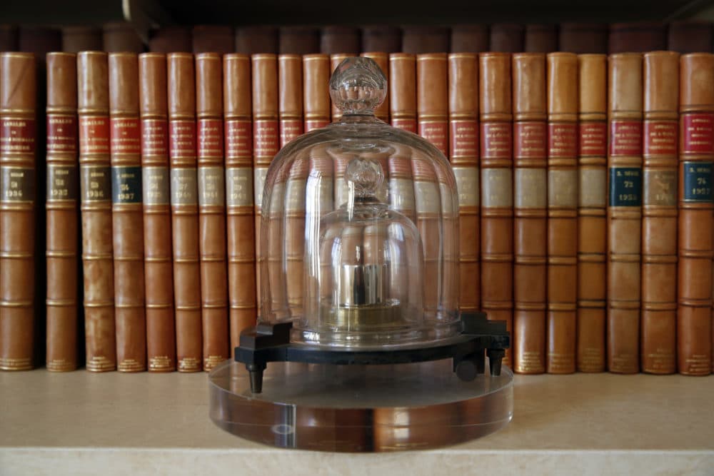 In this photo taken Wednesday, Oct. 17, 2018., a replica of the International Prototype Kilogram is pictured at the International Bureau of Weights and Measures, in Sevres, near Paris. The golf ball-sized metal cylinder at the heart of the world's system for measuring mass is heading into retirement. (Christophe Ena/AP)