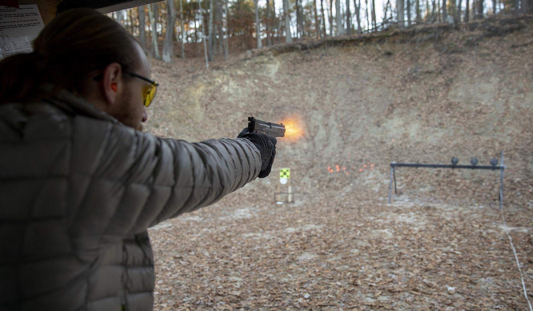 Aaron Grossman, an NRA instructor and leader of the Boston Pink Pistols, fires at targets at the Harvard Sportsmen's Club in Harvard, Mass. (Robin Lubbock/WBUR)