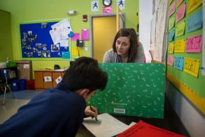Boston Collegiate Charter School teacher Bridget Adam plays a math game based on "Battleship" with one of her sixth grade students. (JesseCosta/WBUR)
