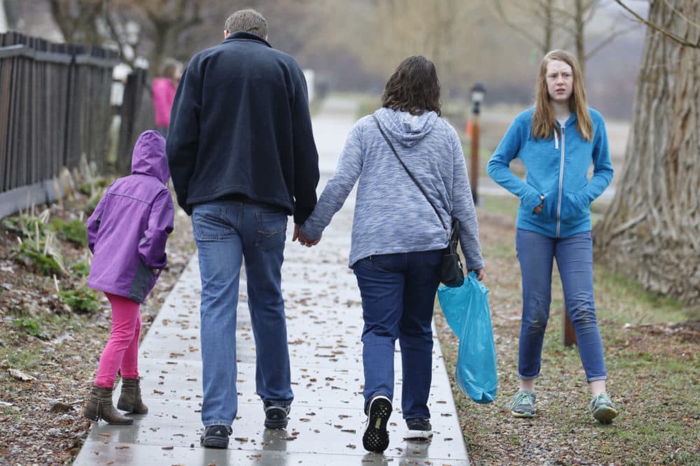 Amy Coulter, center right, and her husband Mark walk together with their children April, 7, left, and Kendra, 12, at the Place Heritage Park in Salt Lake City, April 6, 2018. (Rick Bowmer/AP)