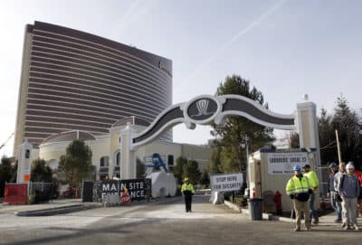Workers stand near an entrance to the under-construction Encore Boston Harbor luxury resort and casino, in Everett, Mass., on Jan. 2, 2019. (Steven Senne/AP)