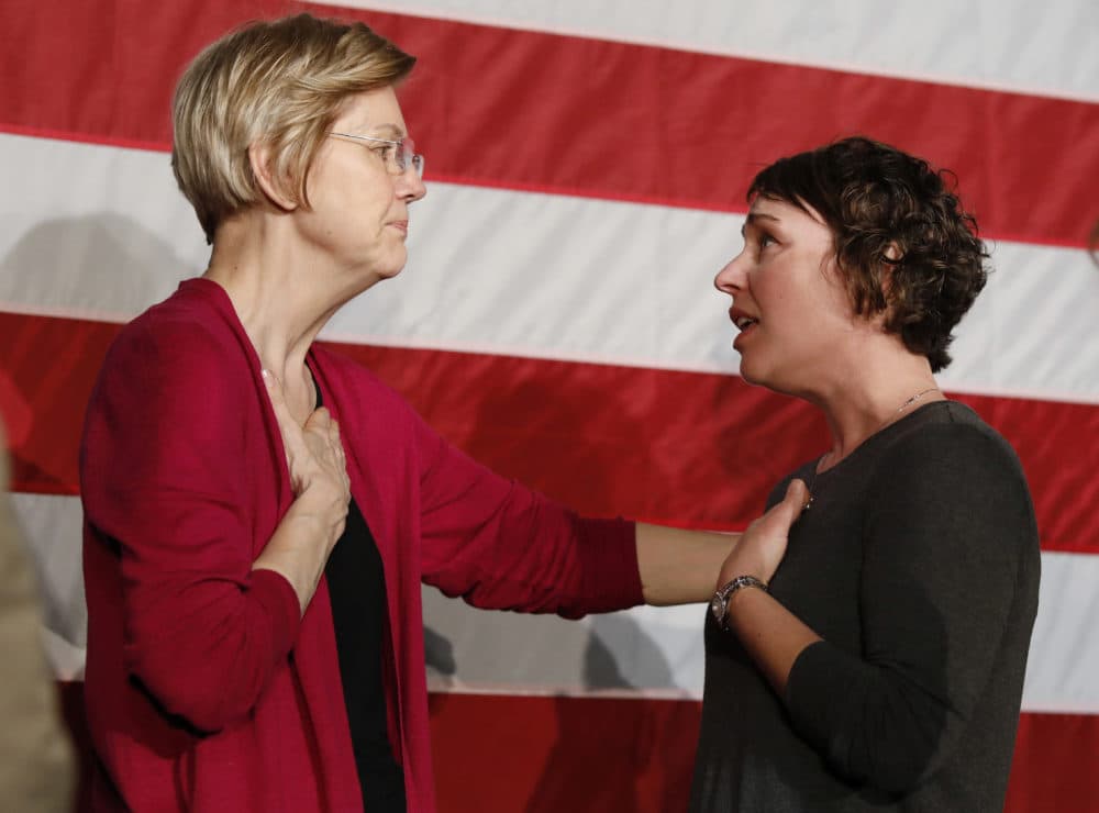 Sen. Elizabeth Warren, D-Mass., left, talks with Christa Lautner of Urbandale about student loans and predatory lending after an organizing event at Curate event space in Des Moines, Iowa, on Saturday. (Matthew Putney/AP)