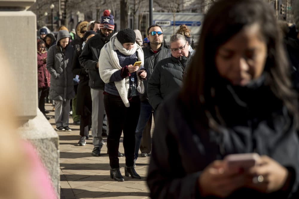 Furloughed government workers affected by the shutdown wait in line for free food and supplies, Tuesday, Jan. 22, 2019, in Washington. An organization devoted to providing meals in the wake of natural disasters set up a distribution center just blocks from the U.S. Capitol building to assist those affected by the government shutdown. (Andrew Harnik/AP)