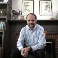 In this Jan. 30, 2019 photo, Dr. Rick Sacra poses at his home in Holden, Mass. Sacra, a Massachusetts missionary doctor who was among a handful of Americans treated and cured of Ebola in 2014, is being honored for his work in Liberia through the deadly epidemic. (Elise Amendola/AP)
