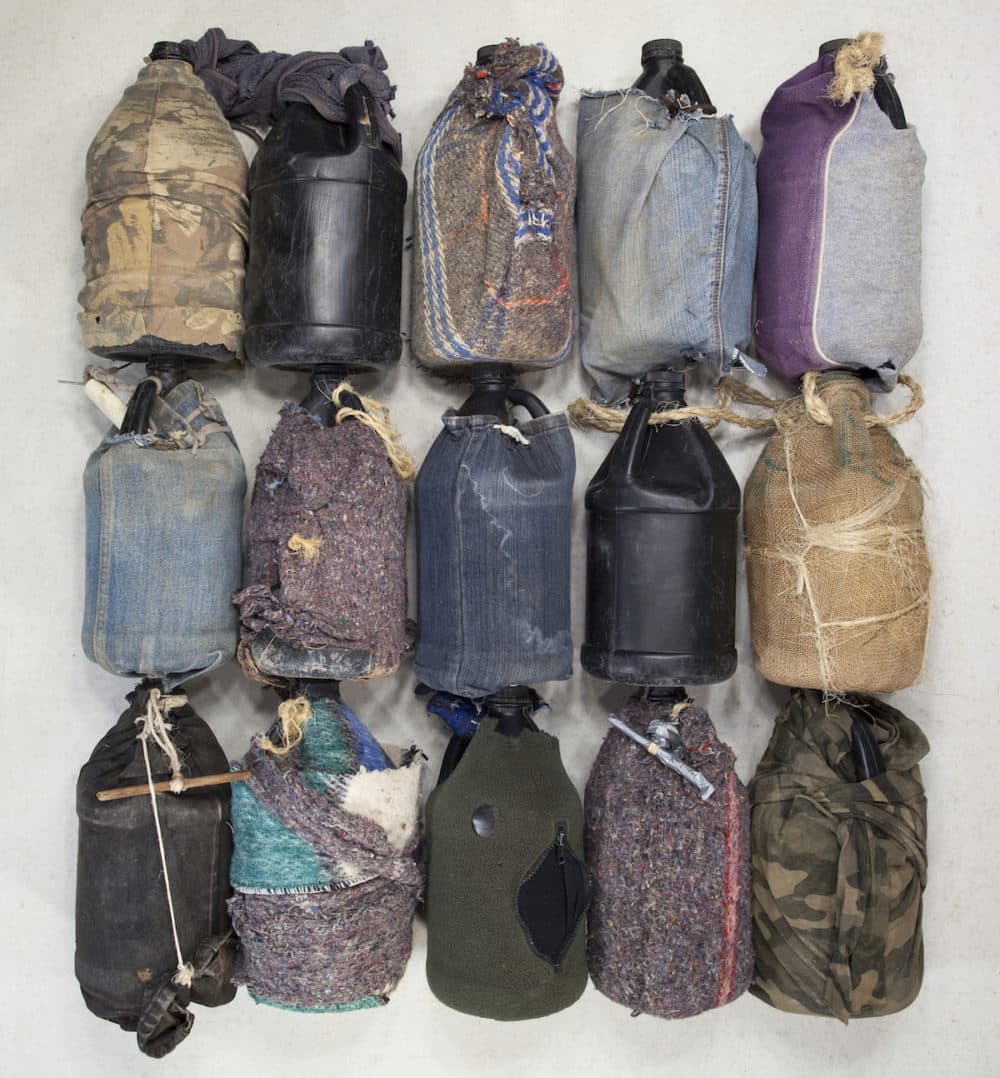 In the Tucson sector of the U.S./Mexico border, heavy-duty non-biodegradable black plastic bottles are commonly used as canteens and are occasionally covered or insulated with remnants of clothing or blanket. (Courtesy of the artist)