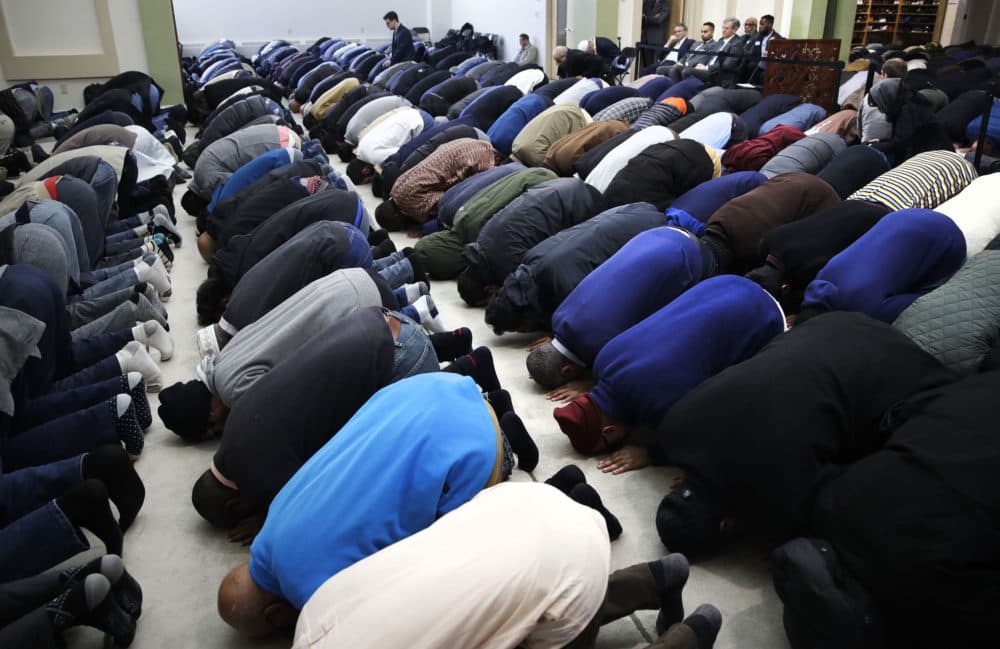 Baker, top right, is seated during the prayer service. (Charles Krupa/AP)