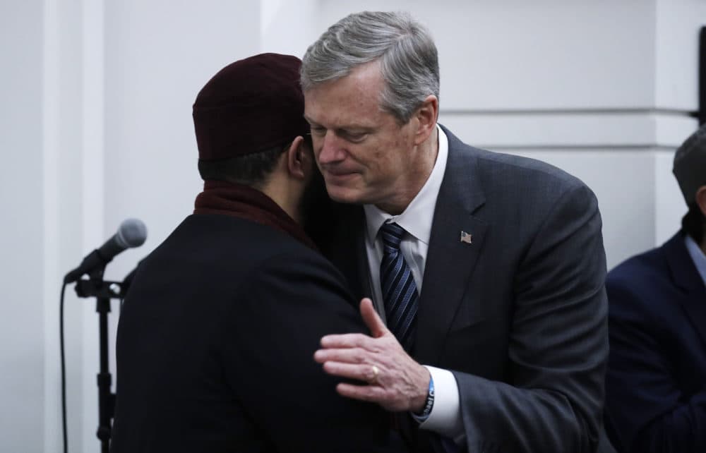 Baker, right, embraces Senior Imam Yasir Fahmy during the prayer service. (Charles Krupa/AP)