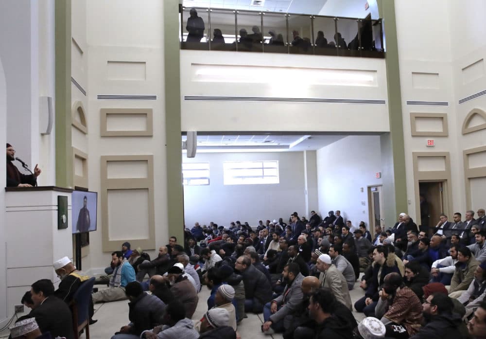 Senior Imam Yasir Fahmy, left, speaks during the prayer service. (Charles Krupa/AP)