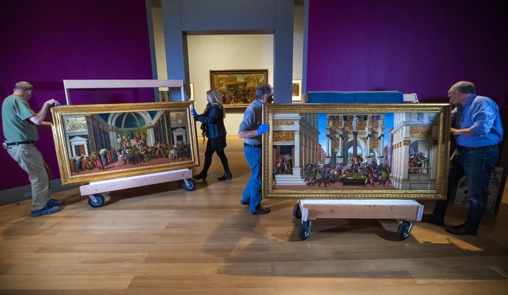 Curators at the Isabella Stewart Gardner Museum inspect and arrange the "The Tragedy of Lucretia" and "The Story of Virginia" by Sandro Botticelli (Jesse Costa/WBUR)
