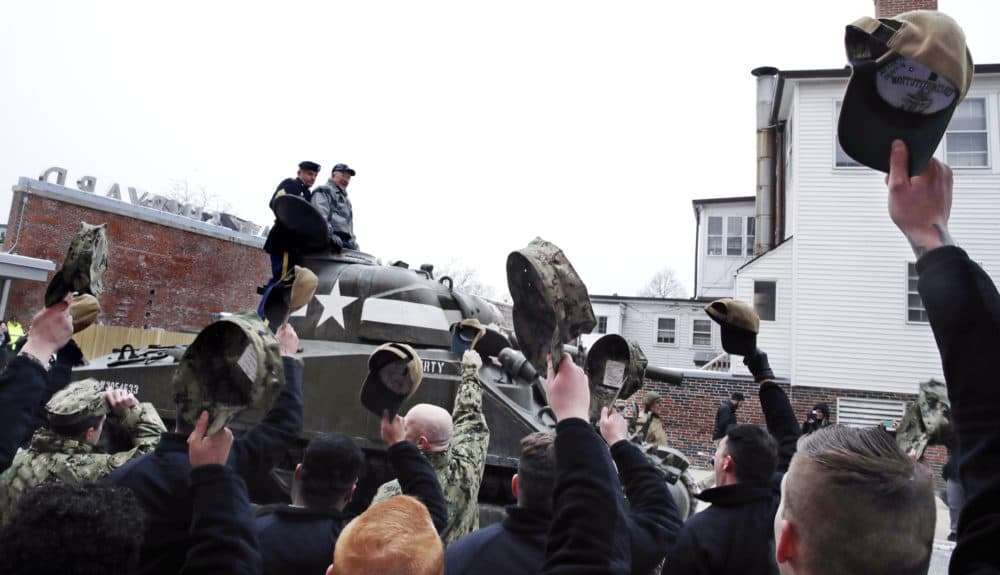 Sailors stationed with the historic frigate USS Constitution doff their caps as World War II tank gunner Clarence Smoyer enters the Charlestown Naval Shipyard in Boston. (Charles Krupa/AP)