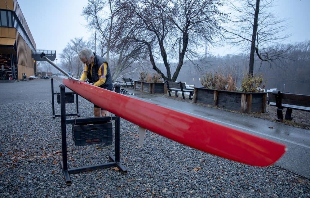 Frederick Hewett prepares a boat at Community Rowing, Inc. for an early morning row on the Charles River. (Robin Lubbock/WBUR)