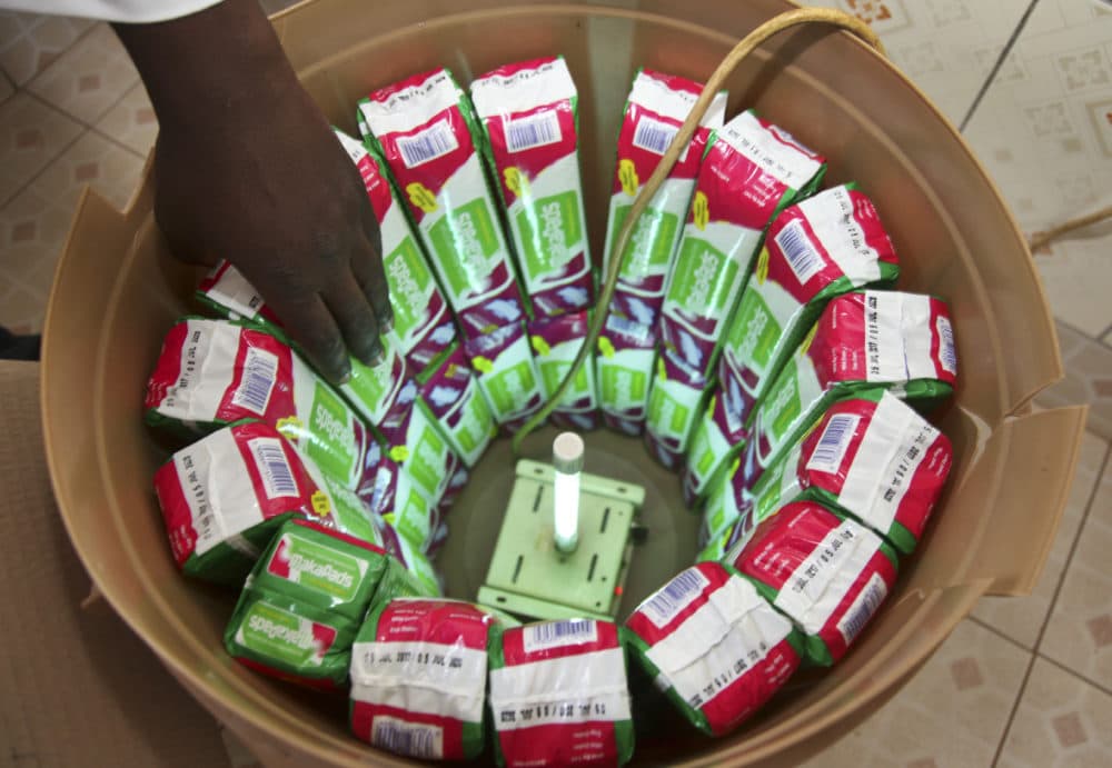 In this photo taken Thursday, July 13, 2017, locally made biodegradable sanitary pads known as Makapads, made from waste paper with papyrus as the absorbent, that sell for half the price of imported pads, are disinfected at the factory in Kampala, Uganda. Menstrual hygiene has emerged as a serious, and often emotional, subject in Africa, where some experts say governments must supply free sanitary pads to girls who are often at risk of dropping out of school because of embarrassment. (Stephen Wandera/AP)