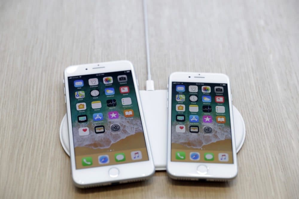 The AirPower wireless charger and iPhones are displayed in the showroom after the new product announcement at the Steve Jobs Theater on the new Apple campus in Cupertino, Calif., Sept. 12, 2017. (Marcio Jose Sanchez, File/AP)