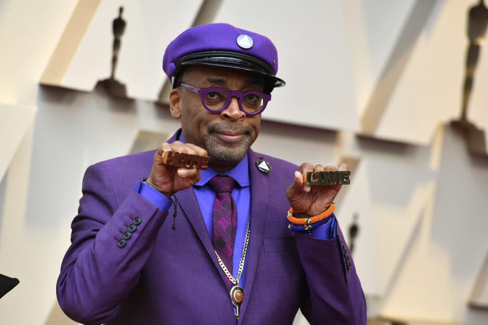 Spike Lee holds up brass knuckles reading "hate" and "love" from his iconic film "Do The Right Thing." (Jordan Strauss/Invision/AP)