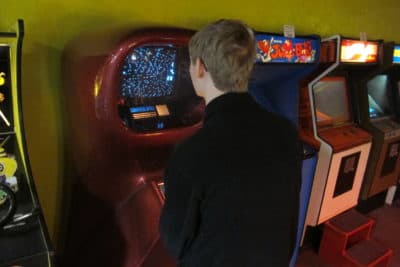 A promising young game design major plays an original Computer Space console from the early ’70s. (Gary Waleik/Only A Game)