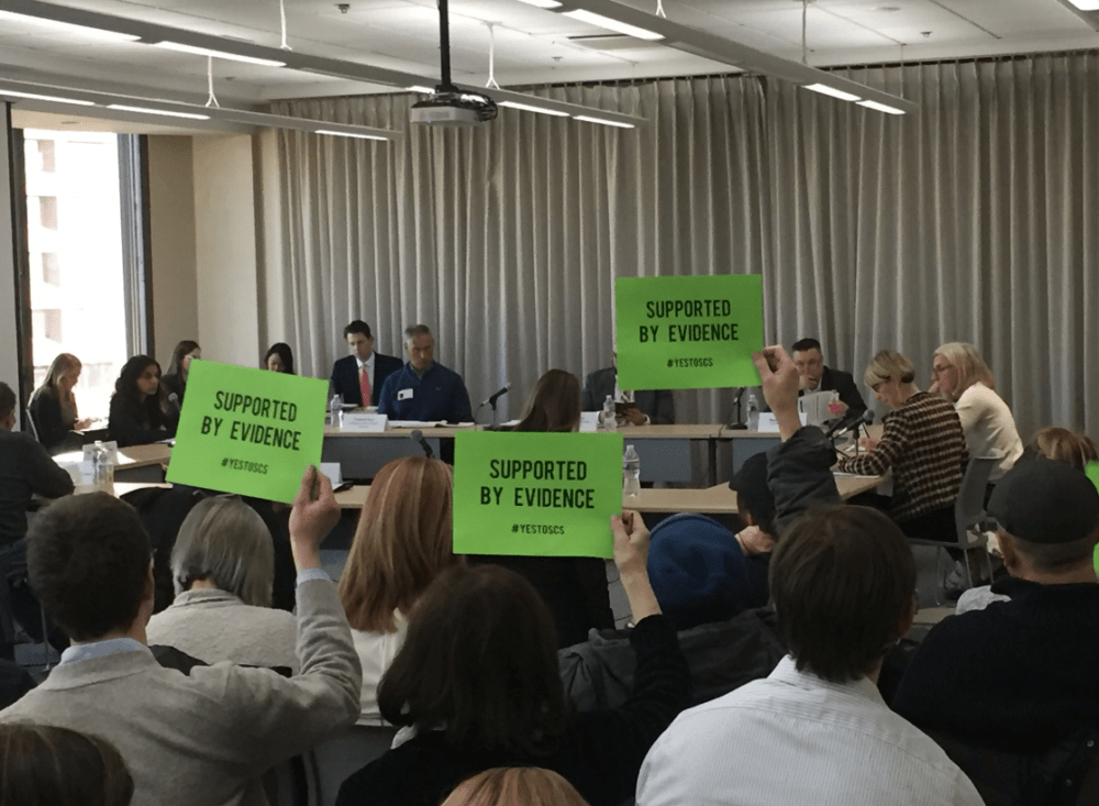 Although public comments were not allowed during Tuesday's special commission meeting on supervised consumption sites, supporters found a way to weigh in. (Martha Bebinger/WBUR)
