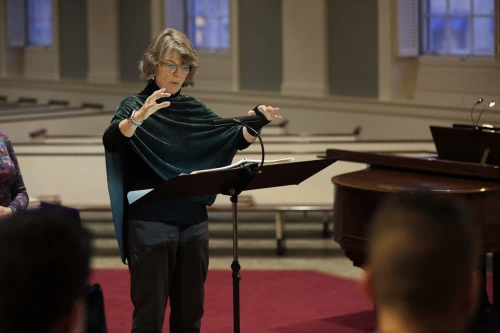 Amelia LeClair, director of Cappella Clausura, conducts a rehearsal at the Eliot Church in Newton.
(Hadley Green for WBUR)