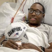 Brunel Etienne receives a blood transfusion at the Kraft Blood Donor Center in Boston. (Robin Lubbock/WBUR)
