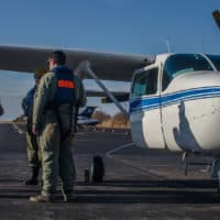 The aerial surveillance team reviews the ditch training procedure before going up in the plane (Sharon Brody/WBUR)