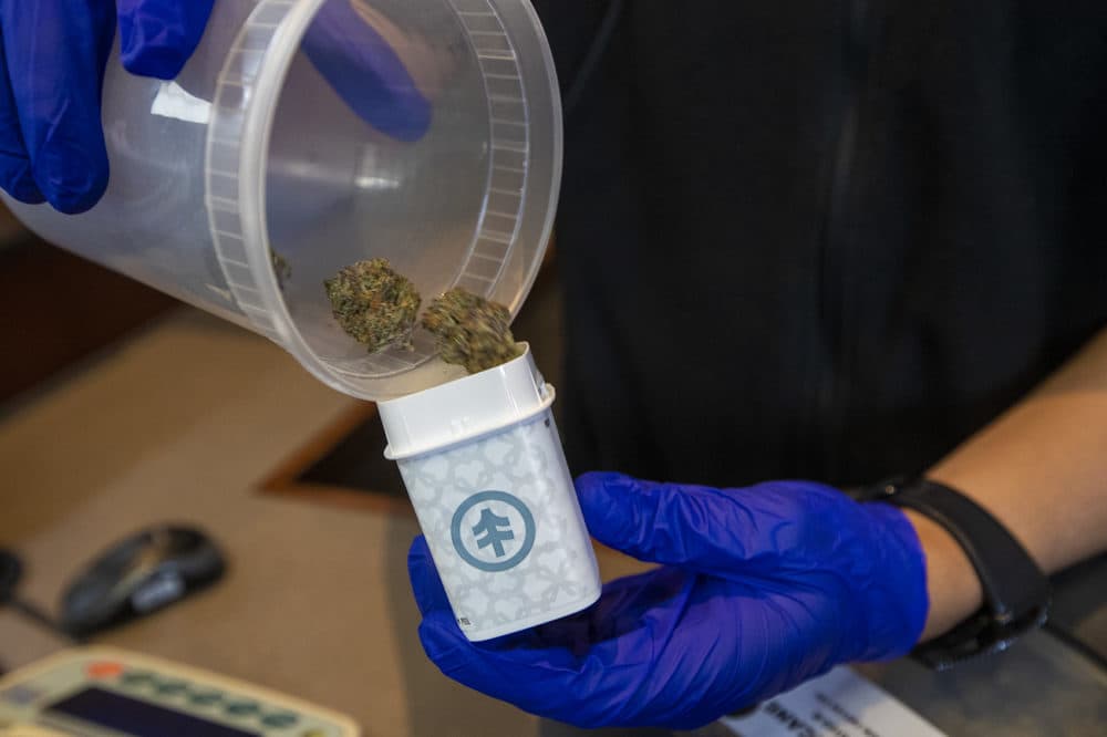 A NETA associate dispenses some of the Bruce Banner strain of cannabis at the Brookline dispensary. (Jesse Costa/WBUR)