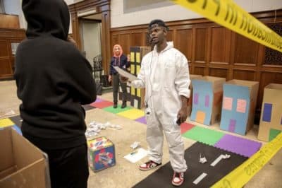 Artist Tory Bullock challenges a contestant to answer a question in "The Gentrification Game." (Robin Lubbock/WBUR)