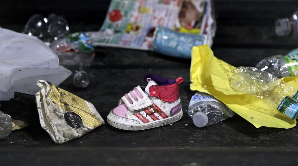 In this 2018 file photo, a child's shoe is co-mingled with recyclable materials at EL Harvey & Sons, a waste and recycling company, in Westborough. (Charles Krupa/AP)