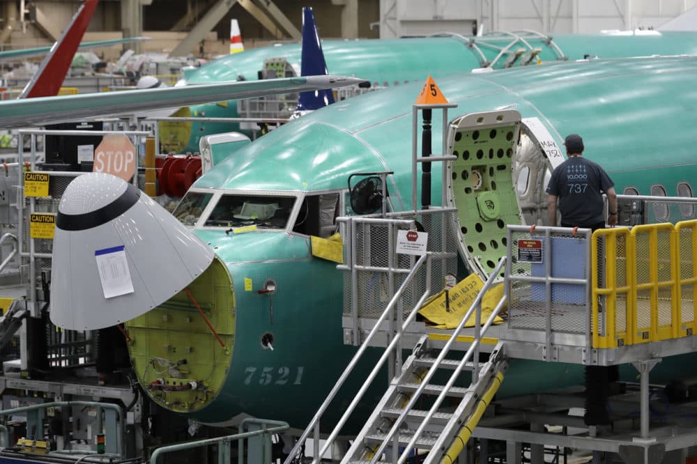 A worker enters a Boeing 737 MAX 8 airplane during a brief media tour of Boeing's 737 assembly facility, Wednesday, March 27, 2019, in Renton, Wash. (Ted S. Warren/AP)