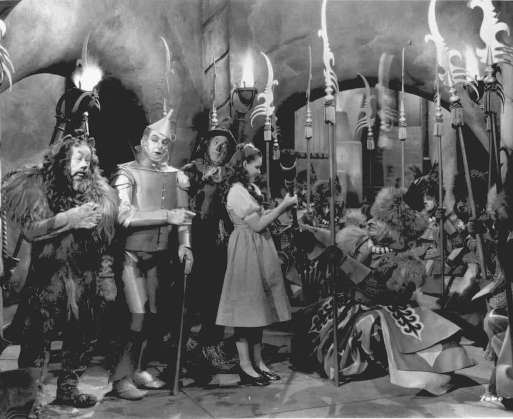 Judy Garland, as Dorothy in "The Wizard of Oz," is presented with the Witch's broom in a scene from the 1939 movie. Garland is accompanied by, from left to right, Bert Lahr as the Cowardly Lion, Jack Haley as the Tin Man, and Ray Bolger as the Scarecrow. (AP Photo)