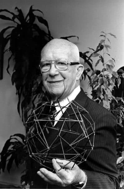 Buckminster Fuller, designer of the geodesic dome, holds a geometric object that he calls tensegrity in 1983. (Suzanne Vlamis/AP)
