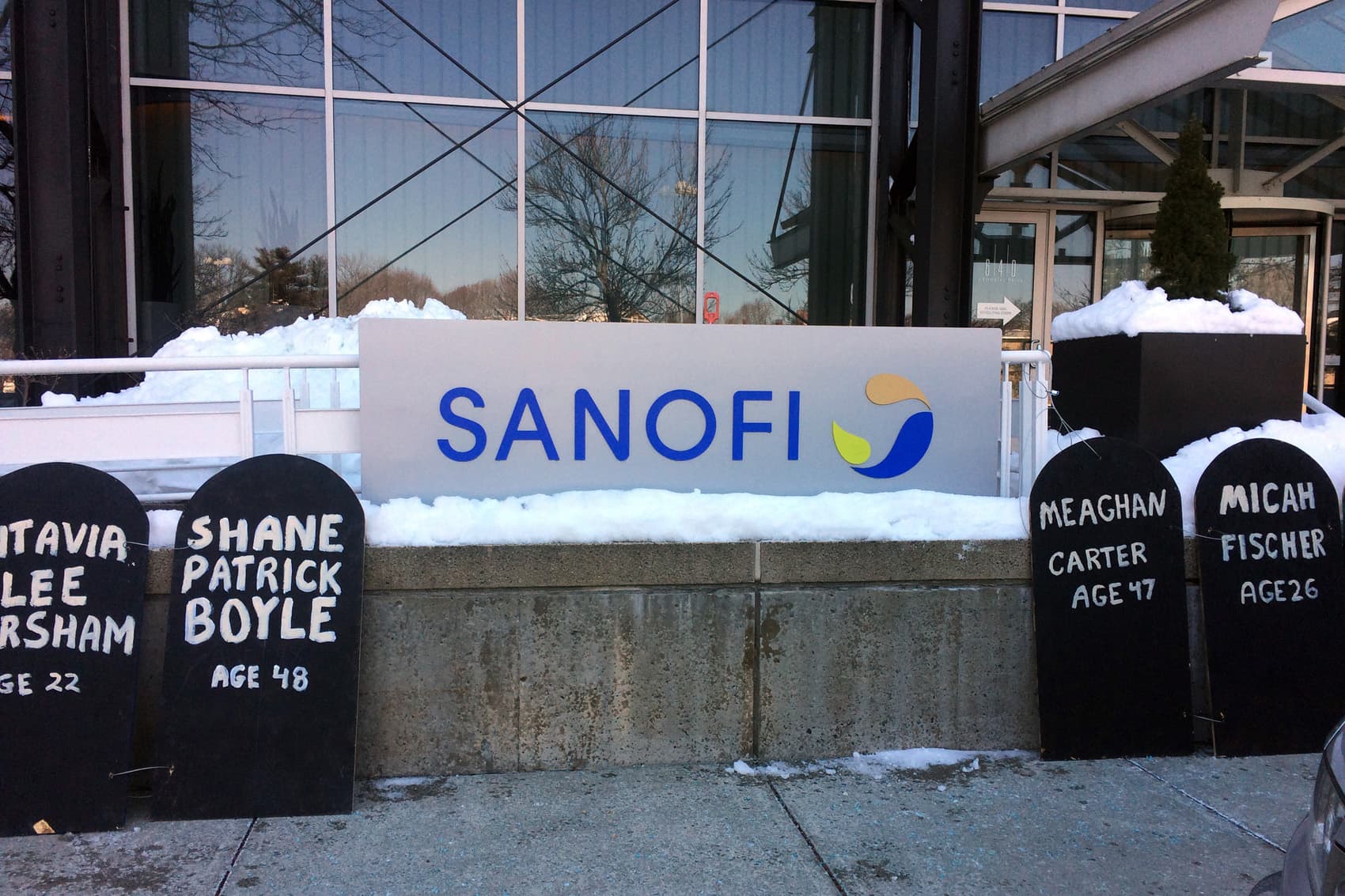 Cardboard headstones line the sidewalk outside of pharmaceutical company Sanofi's Cambridge, Mass., offices. The Right Care Alliance held a protest against high insulin prices, which have led some to the dangerous practice of cutting doses to save. (Anna Bauman/On Point)