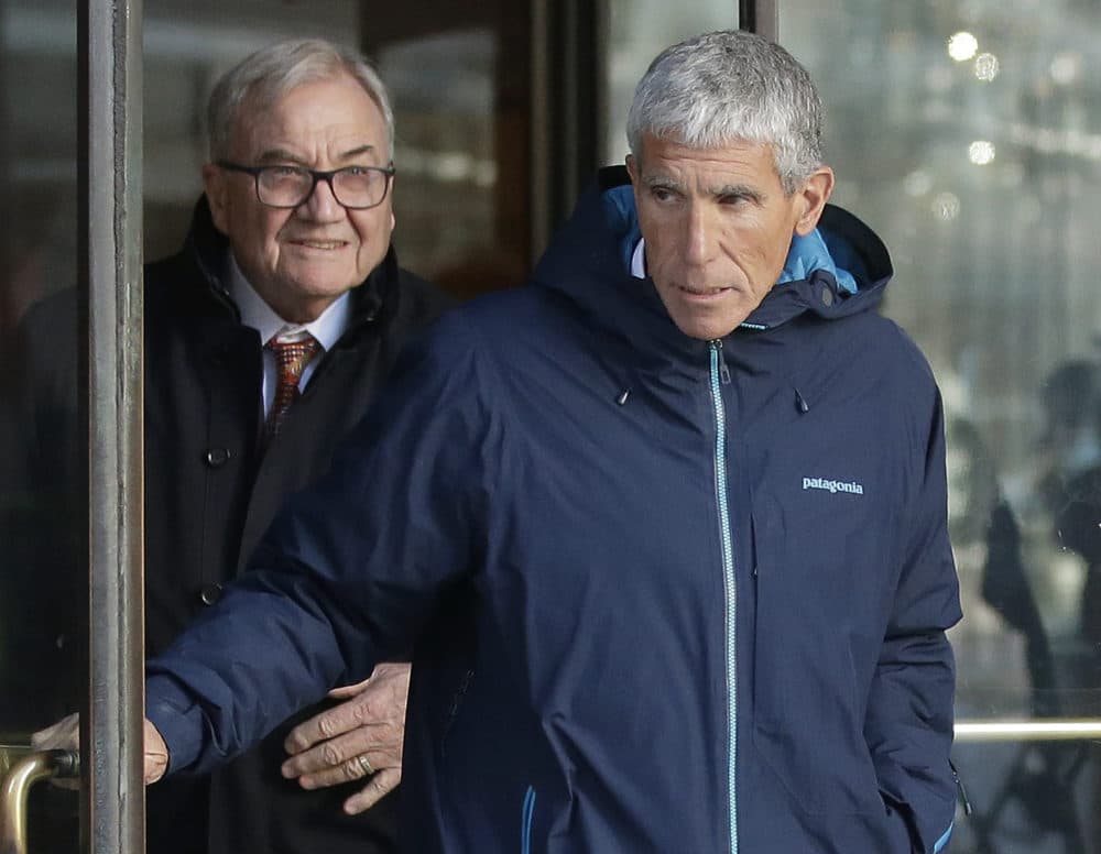 William "Rick" Singer, front, founder of the Edge College & Career Network, exits federal court in Boston on Tuesday, March 12, 2019, after he pleaded guilty to charges in a nationwide college admissions bribery scandal. (Steven Senne/AP)