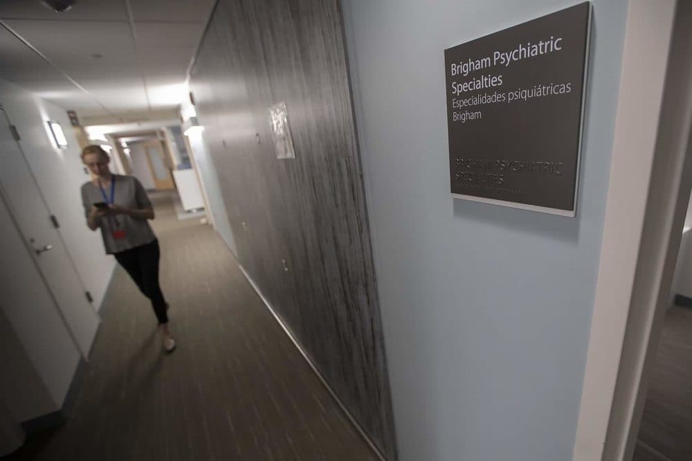 A health care worker walks through a hallway at the Brigham and Women's Psychiatric Specialties Clinic. (Jesse Costa/WBUR)