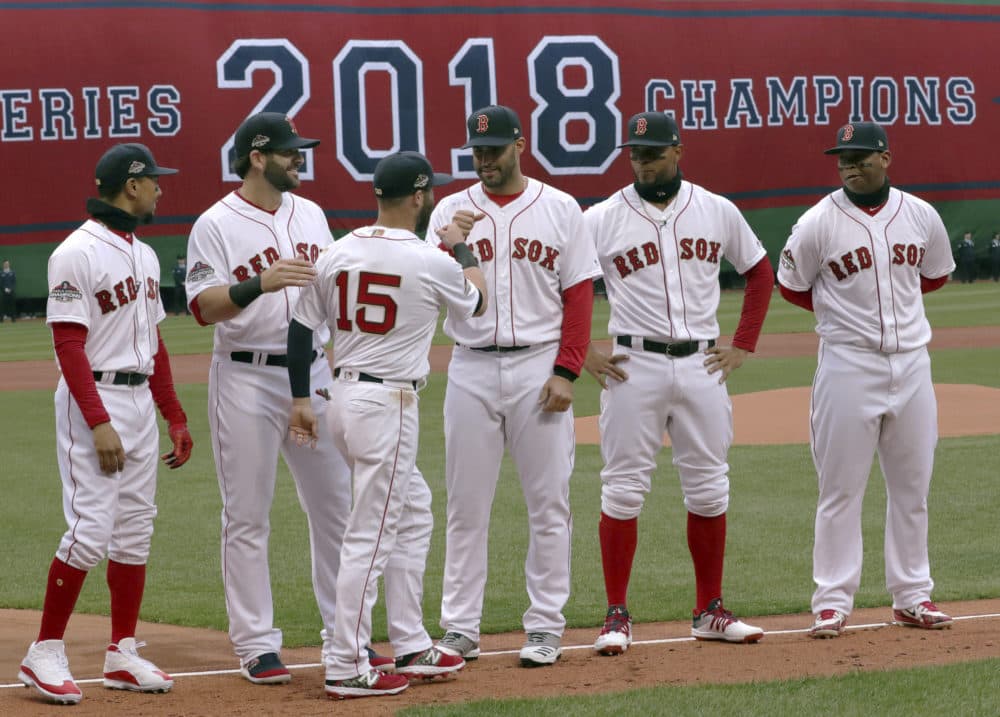 Boston Red Sox second baseman Dustin Pedroia (15) exchanges a fist bump with J.D. Martinez before the home opener baseball game between the Red Sox and the Toronto Blue Jays on April 9. (Charles Krupa/AP)