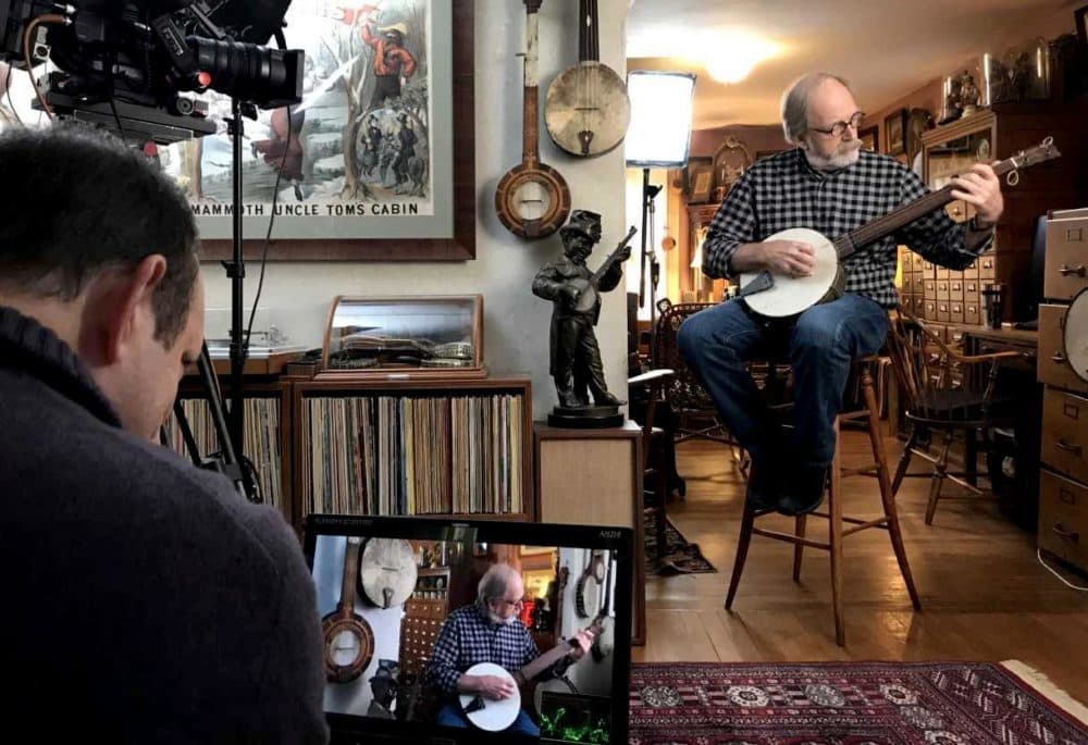 Marc Fields and his team films an interview at Jim Bollman’s house in Arlington. (Andrea Shea/WBUR)