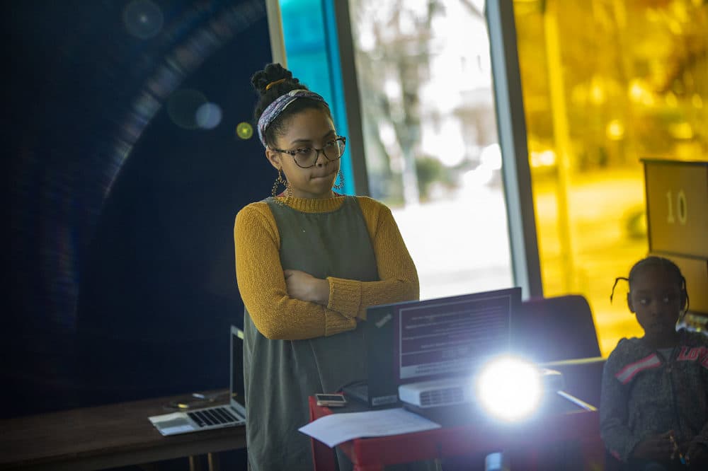 Kyara Andrade shows YouTube videos to students in her workshop. (Jesse Costa/WBUR)