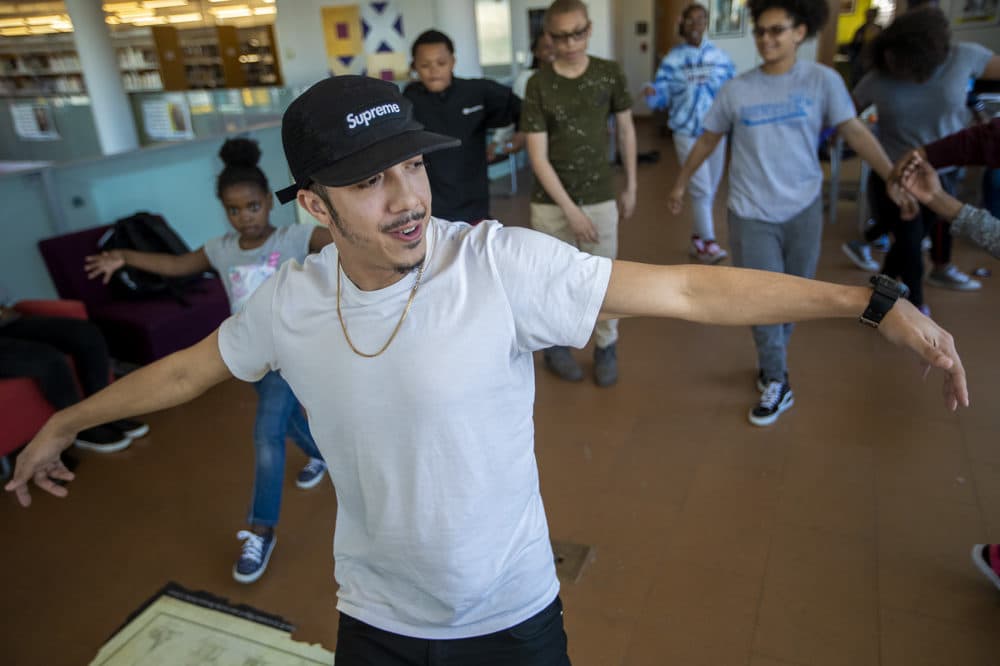Floor Lords Crew dancer Alex Diaz shows students a few moves during "The Breaks" at Grove Hall Library. (Jesse Costa/WBUR)