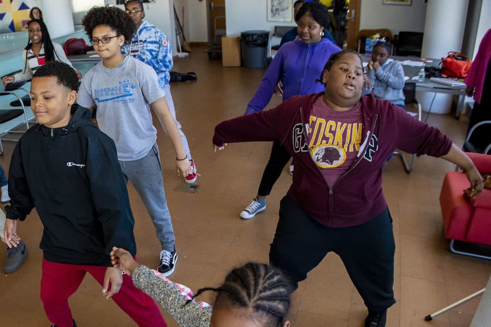 Jerome Wells, right, dances with the rest of the group. (Jesse Costa/WBUR)