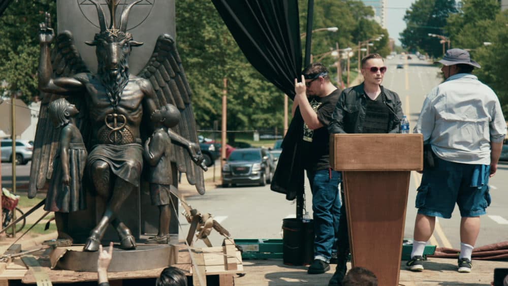 Lucien Greaves delivering a speech in front of the state capitol building in Little Rock, Arkansas, in "Hail Satan?", a Magnolia Pictures release. (Courtesy Magnolia Pictures)