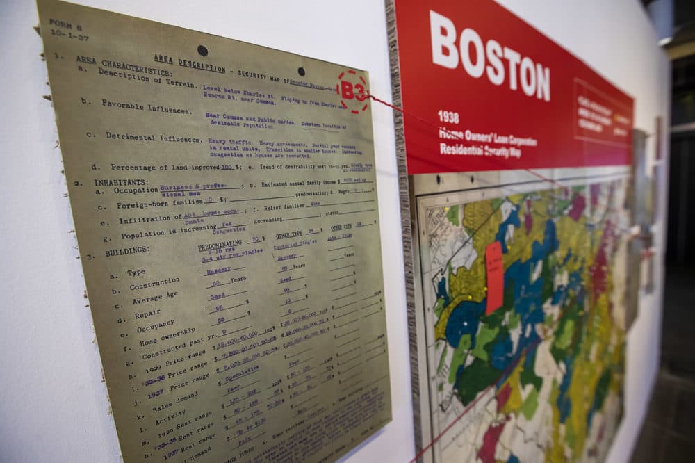 Documents and a map  show examples of redlining in Boston in the "Undesign the Redline: the Transformation of Race, Place, and Class in America" exhibit at the Boston Architectural College. (Jesse Costa/WBUR)