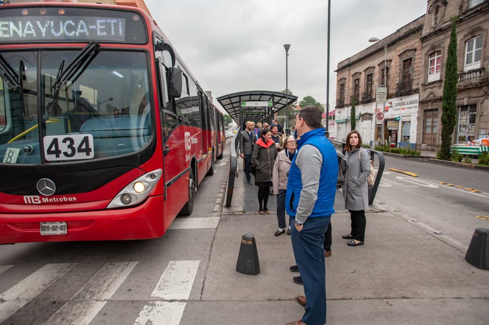 Members of Boston's Alliance for Business Leadership get ready to board a bus in Mexico City to learn about the city’s bus rapid transit system. (Keith Dannemiller for WBUR)