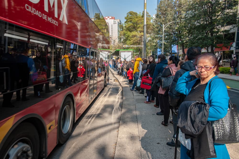 People line up waiting to board Line 7, along Paseo de la Reforma, on the Mexico City Metrobús. (Keith Dannemiller for WBUR)