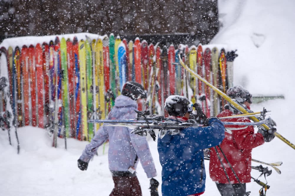 Skiers walk by a ski fence after a day of skiing at Crested Butte, Colo. on Friday, Feb. 19, 2010. (Nathan Bilow/AP)
