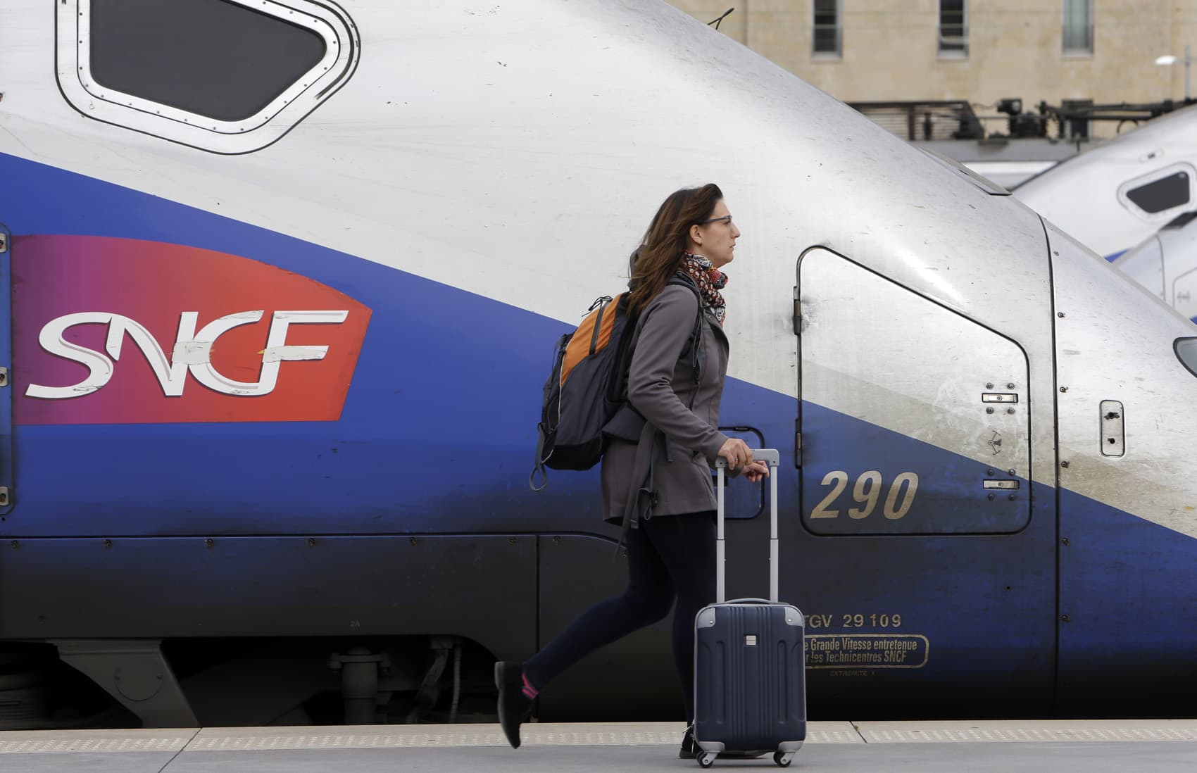 A woman walks past high-speed trains at the Saint Charles station in Marseille, southern France, Tuesday April 3, 2018. (Claude Paris/AP)