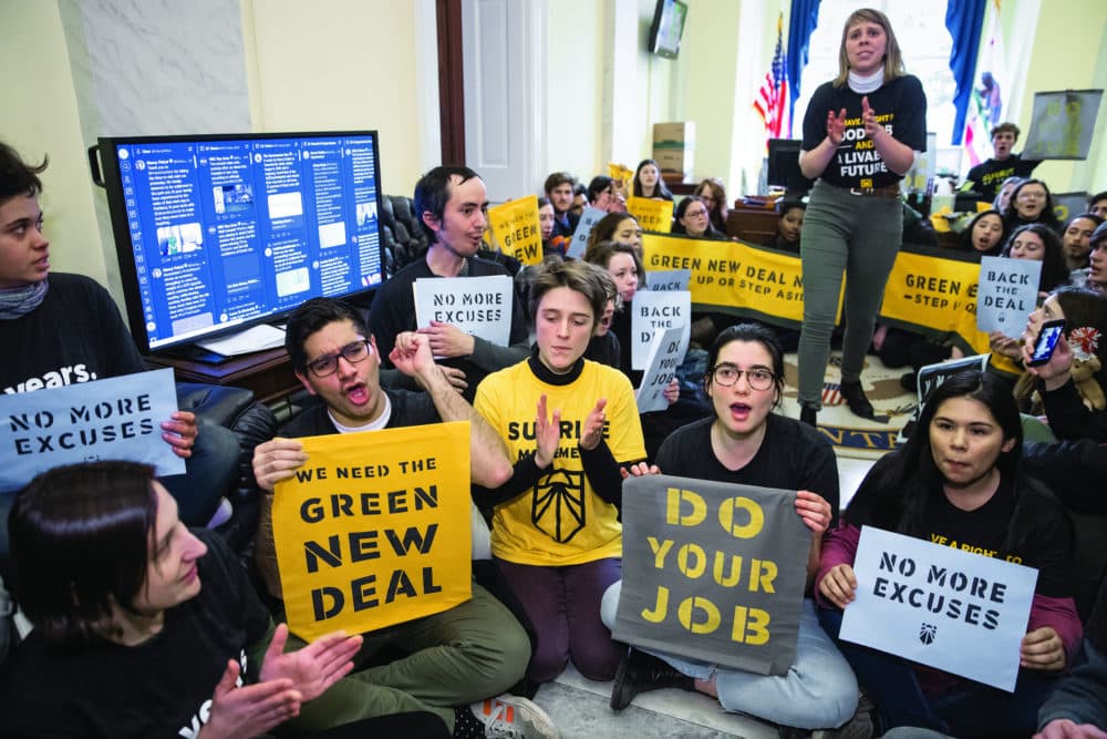 Sunrise Movement activists  occupy the office of House Democratic Leader Nancy Pelosi as they try to pressure Democratic support for a sweeping agenda to fight climate change, on Capitol Hill in Washington, Monday, Dec. 10, 2018. (AP Photo/J. Scott Applewhite)
